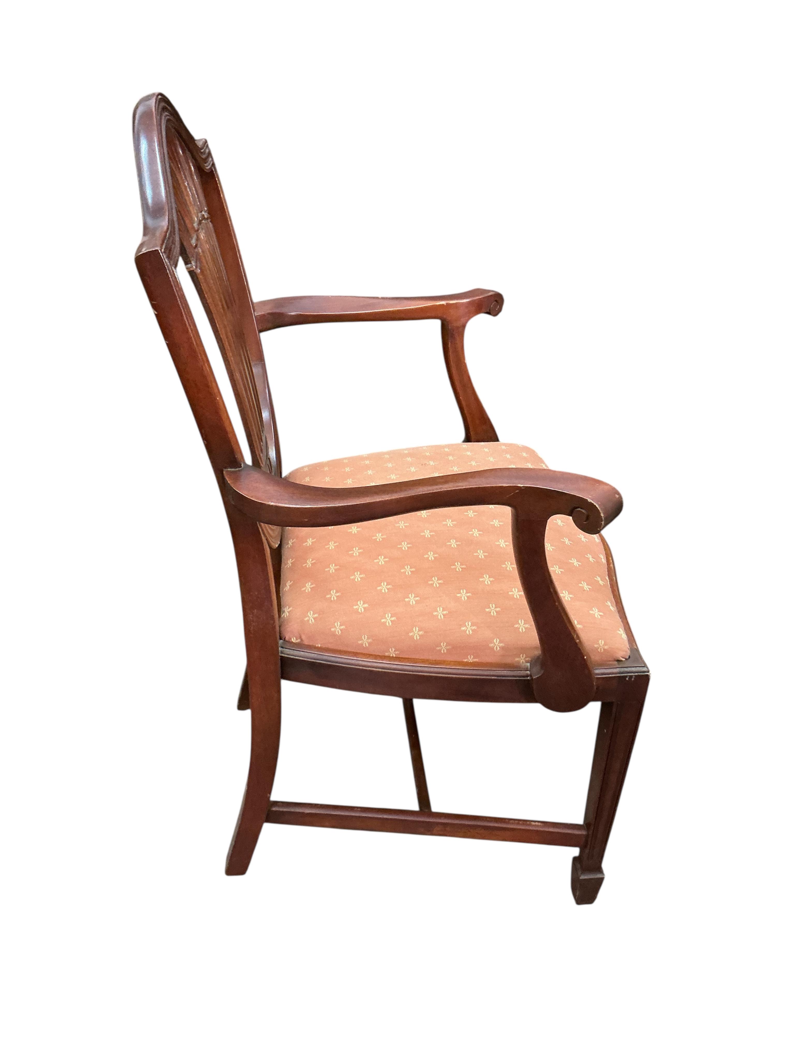A reproduction mahogany twin pillar extending dining table, 216cm extended, one spare leaf, depth 98cm, height 74cm and eight Hepplewhite style dining chairs, two with arms